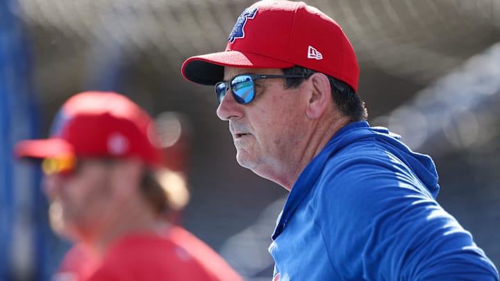   Philadelphia Phillies manager Rob Thomson (59) directs batting practice before a game against the New York Yankees at BayCare Ballpark.