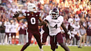 Oct 19, 2024; Starkville, Mississippi, USA;Mississippi State Bulldogs quarterback Michael Van Buren Jr. (0) drops back to pass against Texas A&M Aggies defensive lineman Shemar Stewart (4) during the third quarter at Davis Wade Stadium at Scott Field. Mandatory Credit: Matt Bush-Imagn Images