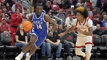 Dec 8, 2024; Louisville, Kentucky, USA;  Duke basketball guard Sion James (14) dribbles against Louisville Cardinals guard Chucky Hepburn (24) during the first half at KFC Yum! Center. Duke defeated Louisville 76-65.