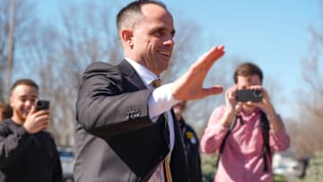 Iowa's new head men's basketball coach Ben McCollum waves at the assembled crowd while walking into his introductory press conference Tuesday, March 25, 2025 at Carver-Hawkeye Arena in Iowa City, Iowa.