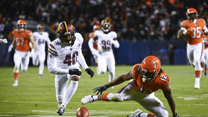 Oct 13, 2022; Chicago, Illinois, USA; Chicago Bears wide receiver Velus Jones Jr. (12) fumbles a kick off return as Washington Commanders cornerback Tariq Castro-Fields (40) defends during the second half at Soldier Field. Mandatory Credit: Matt Marton-USA TODAY Sports