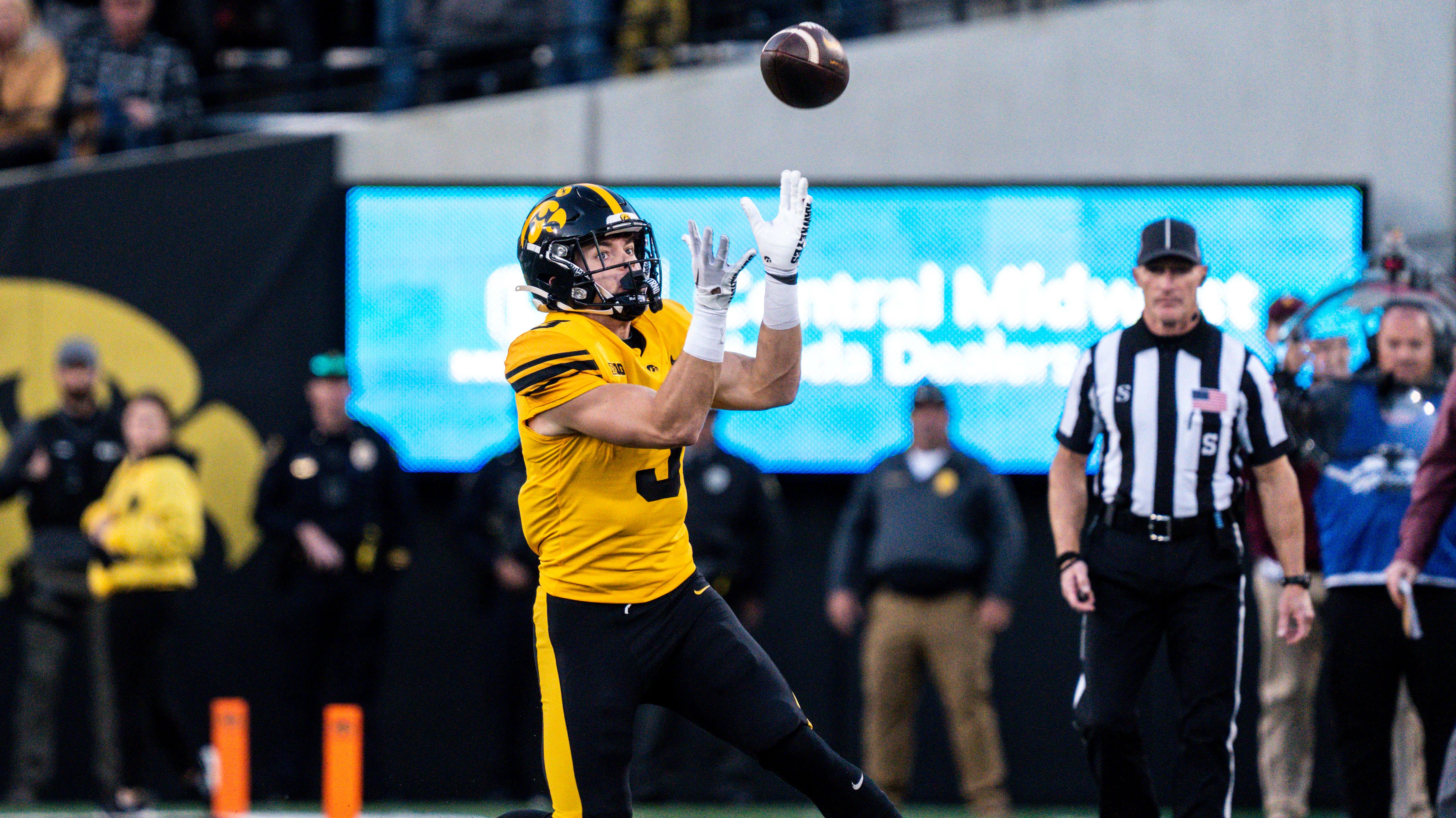 Iowa defensive back Cooper DeJean (3) catches a punt at Kinnick Stadium.