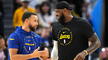 Dec 25, 2024; San Francisco, California, USA; Golden State Warriors guard Stephen Curry (left) and Los Angeles Lakers forward LeBron James (right) talk before the game at Chase Center.