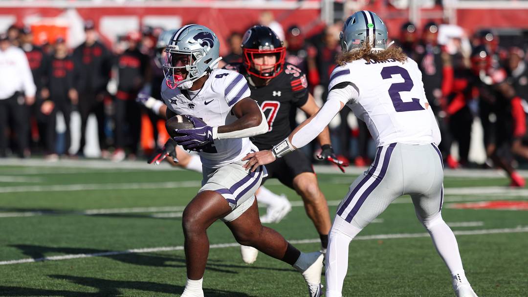 Nov 22, 2025; Salt Lake City, Utah, USA; Kansas State Wildcats quarterback Avery Johnson (2) hands the ball off to wide receiver Jayce Brown (1) during the first half of the game against the Utah Utes at Rice-Eccles Stadium. Mandatory Credit: Rob Gray-Imagn Images