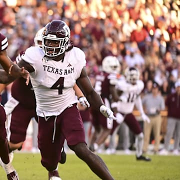Oct 19, 2024; Starkville, Mississippi, USA;Mississippi State Bulldogs quarterback Michael Van Buren Jr. (0) drops back to pass against Texas A&M Aggies defensive lineman Shemar Stewart (4) during the third quarter at Davis Wade Stadium at Scott Field. Mandatory Credit: Matt Bush-Imagn Images