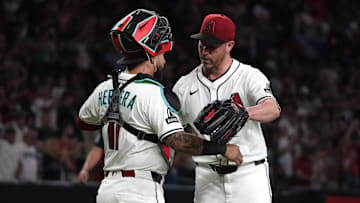Jul 19, 2025; Phoenix, Arizona, USA; Arizona Diamondbacks catcher Jose Herrera (11) and pitcher Anthony DeSclafani (21) celebrates after defeating the St. Louis Cardinals at Chase Field. Mandatory Credit: Rick Scuteri-Imagn Images