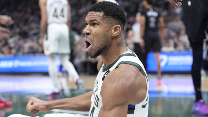 Jan 2, 2025; Milwaukee, Wisconsin, USA; Milwaukee Bucks forward Giannis Antetokounmpo (34) reacts after being fouled driving to the basket against the Brooklyn Nets in the first halfat Fiserv Forum. Mandatory Credit: Michael McLoone-Imagn Images