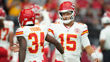 Kansas City Chiefs quarterback Patrick Mahomes (15) greets teammate Elijah Young (34) before their preseason game against the Arizona Cardinals at State Farm Stadium on Aug. 9, 2025.