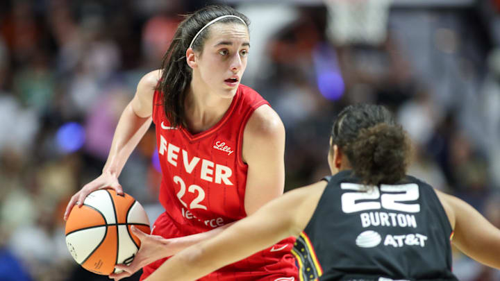 Sep 25, 2024; Uncasville, Connecticut, USA; Indiana Fever guard Caitlin Clark (22) possesses the ball during the first half against the Connecticut Sun during game two of the first round of the 2024 WNBA Playoffs at Mohegan Sun Arena. Mandatory Credit: Paul Rutherford-Imagn Images
