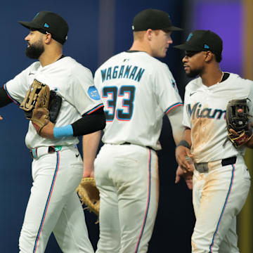 Jul 3, 2025; Miami, Florida, USA; Miami Marlins center fielder Derek Hill (3) celebrates with relief pitcher Ronny Henriquez (32) after the game against the Minnesota Twins at loanDepot Park. Mandatory Credit: Sam Navarro-Imagn Images