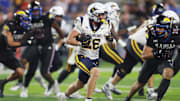 West Virginia Mountaineers running back Tyler Jacklich (28) runs the ball during the second half of the game against Kansas Jayhawks at David Booth Kansas Memorial Stadium on Sept. 20, 2025.