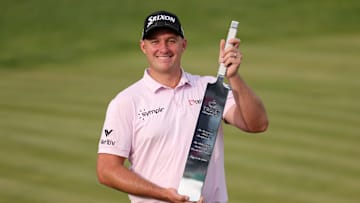 Sepp Straka holds the winner's trophy following his victory at the 2025 Truist Championship at Philadelphia Cricket Club
