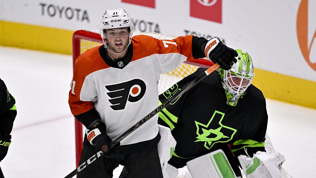 Mar 22, 2025; Dallas, Texas, USA; Philadelphia Flyers right wing Tyson Foerster (71) looks for the puck in front of Dallas Stars goaltender Jake Oettinger (29) during the third period at the American Airlines Center. Mandatory Credit: Jerome Miron-Imagn Images