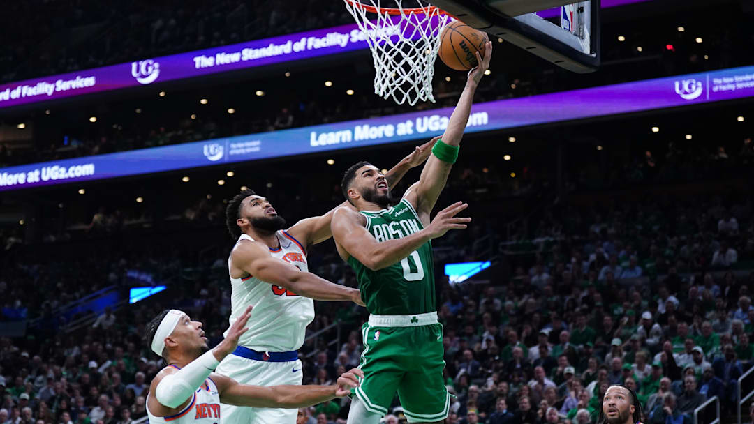 Oct 22, 2024; Boston, Massachusetts, USA; Boston Celtics forward Jayson Tatum (0) drives to the basket against New York Knicks center Karl-Anthony Towns (32) in the second quarter at TD Garden. Mandatory Credit: David Butler II-Imagn Images