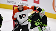 Mar 22, 2025; Dallas, Texas, USA; Philadelphia Flyers right wing Tyson Foerster (71) looks for the puck in front of Dallas Stars goaltender Jake Oettinger (29) during the third period at the American Airlines Center. Mandatory Credit: Jerome Miron-Imagn Images