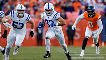 Dec 15, 2024; Denver, Colorado, USA; Indianapolis Colts tight end Kylen Granson (83) runs the ball as center Danny Pinter (63) defends as Denver Broncos linebacker Jonathon Cooper (0) chases in the second quarter at Empower Field at Mile High. Mandatory Credit: Isaiah J. Downing-Imagn Images