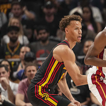 Apr 18, 2025; Atlanta, Georgia, USA; Miami Heat forward Andrew Wiggins (22) controls the ball against Atlanta Hawks guard Dyson Daniels (5) during the first half at State Farm Arena. Mandatory Credit: Dale Zanine-Imagn Images