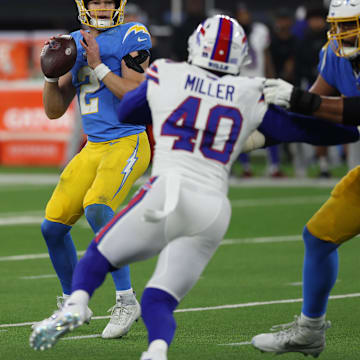 Dec 23, 2023; Inglewood, California, USA;  Los Angeles Chargers quarterback Easton Stick (2) looks to pass as offensive tackle Trey Pipkins III (79) blocks Buffalo Bills linebacker Von Miller (40) during the third quarter at SoFi Stadium 