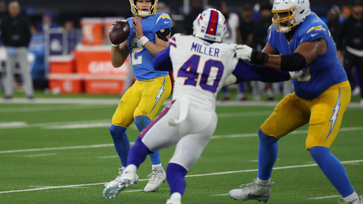 Dec 23, 2023; Inglewood, California, USA;  Los Angeles Chargers quarterback Easton Stick (2) looks to pass as offensive tackle Trey Pipkins III (79) blocks Buffalo Bills linebacker Von Miller (40) during the third quarter at SoFi Stadium 