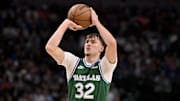 Oct 26, 2025; Dallas, Texas, USA; Dallas Mavericks forward Cooper Flagg (32) makes a three point shot against the Toronto Raptors during the second half at the American Airlines Center. Mandatory Credit: Jerome Miron-Imagn Images