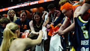 May 27, 2025; Uncasville, Connecticut, USA; Dallas Wings guard Paige Bueckers (5) signs autographs before the start of the game against the Connecticut Sun at Mohegan Sun Arena. Mandatory Credit: David Butler II-Imagn Images