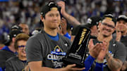Oct 18, 2025; Los Angeles, California, USA;  Los Angeles Dodgers two-way player Shohei Ohtani (17) holds the MVP trophy after defeating the Milwaukee Brewers in game five of the NLCS during the 2025 MLB playoffs at Dodger Stadium. Mandatory Credit: Jayne Kamin-Oncea-Imagn Images