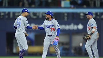 Oct 31, 2025; Toronto, Ontario, CAN; Los Angeles Dodgers shortstop Mookie Betts (50) and center fielder Justin Dean (75) celebrate after defeating the Toronto Blue Jays during game six of the 2025 MLB World Series at Rogers Centre. Mandatory Credit: John E. Sokolowski-Imagn Images