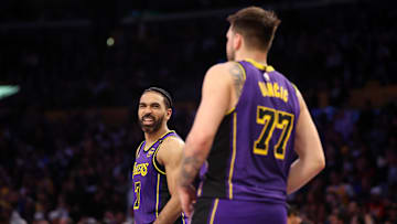 Mar 31, 2025; Los Angeles, California, USA;  Los Angeles Lakers guard Gabe Vincent (7) talks to guard Luka Doncic (77) during the fourth quarter against the Houston Rockets at Crypto.com Arena. Mandatory Credit: Kiyoshi Mio-Imagn Images