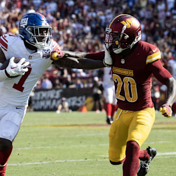 Sep 15, 2024; Landover, Maryland, USA; New York Giants wide receiver Malik Nabers (1) stiff arms Washington Commanders safety Quan Martin (20) in the second half at Commanders Field. Mandatory Credit: Luke Johnson-Imagn Images

