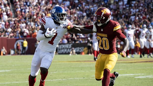 New York Giants wide receiver Malik Nabers (1) stiff arms Washington Commanders safety Quan Martin (20) in the second half\