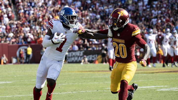 Sep 15, 2024; Landover, Maryland, USA; New York Giants wide receiver Malik Nabers (1) stiff arms Washington Commanders safety Quan Martin (20) in the second half at Commanders Field. Mandatory Credit: Luke Johnson-Imagn Images

