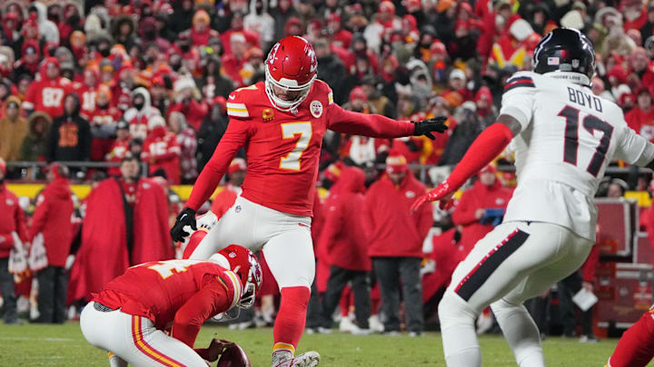 Jan 18, 2025; Kansas City, Missouri, USA; Kansas City Chiefs place kicker Harrison Butker (7) kicks a 27 yard field goal from the hold of punter Matt Araiza (14) against the Houston Texans during the fourth quarter of a 2025 AFC divisional round game at GEHA Field at Arrowhead Stadium. Mandatory Credit: Denny Medley-Imagn Images