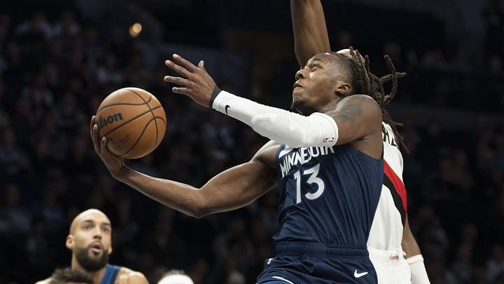 Feb 11, 2026; Minneapolis, Minnesota, USA; Minnesota Timberwolves guard Ayo Dosunmu (13) drives to the basket and shoots the ball against the Portland Trail Blazers in the second half at Target Center. Mandatory Credit: Jesse Johnson-Imagn Images