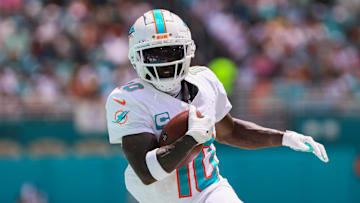Sep 8, 2024; Miami Gardens, Florida, USA; Miami Dolphins wide receiver Tyreek Hill (10) runs with the football against the Jacksonville Jaguars during the first quarter at Hard Rock Stadium. Mandatory Credit: Sam Navarro-Imagn Images