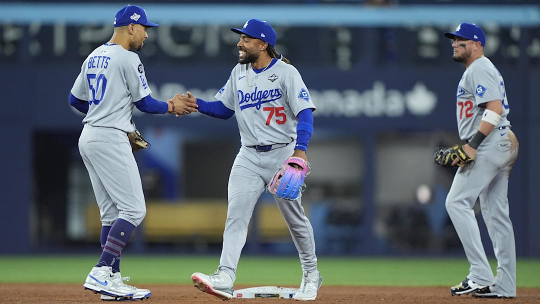 Oct 31, 2025; Toronto, Ontario, CAN; Los Angeles Dodgers shortstop Mookie Betts (50) and center fielder Justin Dean (75) celebrate after defeating the Toronto Blue Jays during game six of the 2025 MLB World Series at Rogers Centre. Mandatory Credit: John E. Sokolowski-Imagn Images