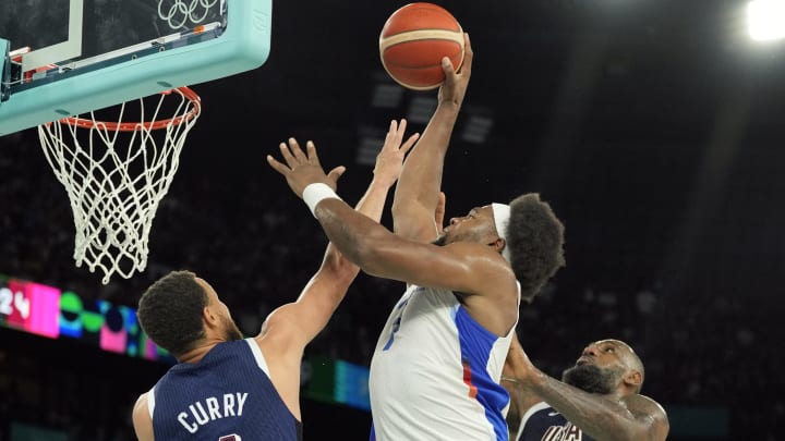 Aug 10, 2024; Paris, France; France power forward Guerschon Yabusele (7) shoots against United States shooting guard Stephen Curry (4) and guard LeBron James (6) in the second half in the men's basketball gold medal game during the Paris 2024 Olympic Summer Games at Accor Arena. Mandatory Credit: Kyle Terada-USA TODAY Sports