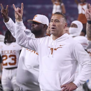 Texas Longhorns head coach Steve Sarkisian and team gesture after the game against the Georgia Bulldogs at Sanford Stadium. 