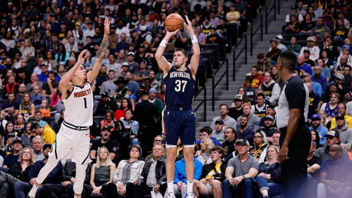 Nov 6, 2023; Denver, Colorado, USA; New Orleans Pelicans forward Matt Ryan (37) attempts a shot under pressure from Denver Nuggets forward Michael Porter Jr. (1) in the second quarter at Ball Arena. Mandatory Credit: Isaiah J. Downing-USA TODAY Sports