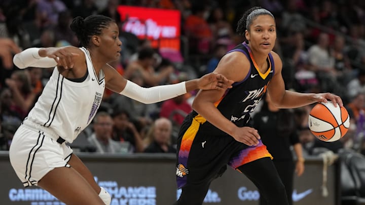 Aug 22, 2025; Phoenix, Arizona, USA; Phoenix Mercury forward Alyssa Thomas (25) drives around Golden State Valkyries center Temi Fagbenle (14) in the second half at Footprint Center. Mandatory Credit: Rick Scuteri-Imagn Images