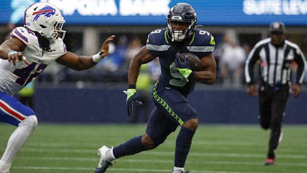 Seattle Seahawks backwards Kenneth Walker III (9) rushes against the secondary of the Buffalo Bills Dorian Williams (42).
