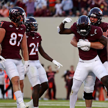 Sep 7, 2024; Blacksburg, Virginia, USA; Virginia Tech Hokies wide receiver Da'Quan Felton (9) celebrates with his teammates after making a touchdown catch during the fourth quarter against the Marshall Thundering Herd at Lane Stadium. Mandatory Credit: Peter Casey-Imagn Images