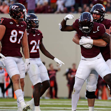 Sep 7, 2024; Blacksburg, Virginia, USA; Virginia Tech Hokies wide receiver Da'Quan Felton (9) celebrates with his teammates after making a touchdown catch during the fourth quarter against the Marshall Thundering Herd at Lane Stadium. Mandatory Credit: Peter Casey-Imagn Images