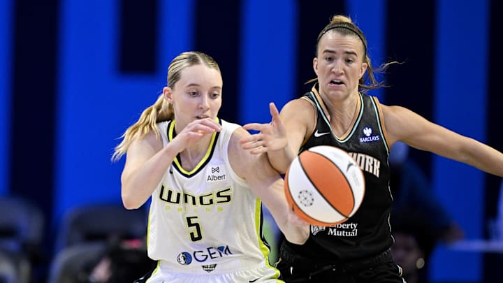Jul 28, 2025; Arlington, Texas, USA; Dallas Wings guard Paige Bueckers (5) is fouled by New York Liberty guard Sabrina Ionescu (20) during the second half at College Park Center. Mandatory Credit: Jerome Miron-Imagn Images Jul 28, 2025; Arlington, Texas, USA; Dallas Wings guard Paige Bueckers (5) is fouled by New York Liberty guard Sabrina Ionescu (20) during the second half at College Park Center. Mandatory Credit: Jerome Miron-Imagn Images