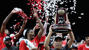 Mar 30, 2025; Indianapolis, IN, USA; Houston Cougars head coach Kelvin Sampson holds the trophy on stage after defeating the Tennessee Volunteers during the Midwest Regional final of the 2025 NCAA tournament at Lucas Oil Stadium. Mandatory Credit: Trevor Ruszkowski-Imagn Images