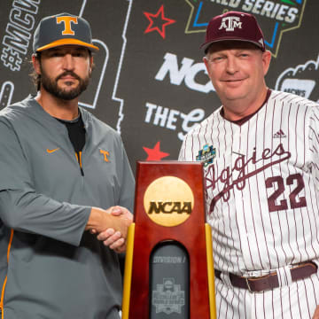 Tennessee head coach Tony Vitello and Texas A&M head coach Jim Schlossnagle pose for a photo with the championship trophy during a press conference before the NCAA College World Series finals at Charles Schwab Field in Omaha, Neb., on Friday, June 21, 2024.