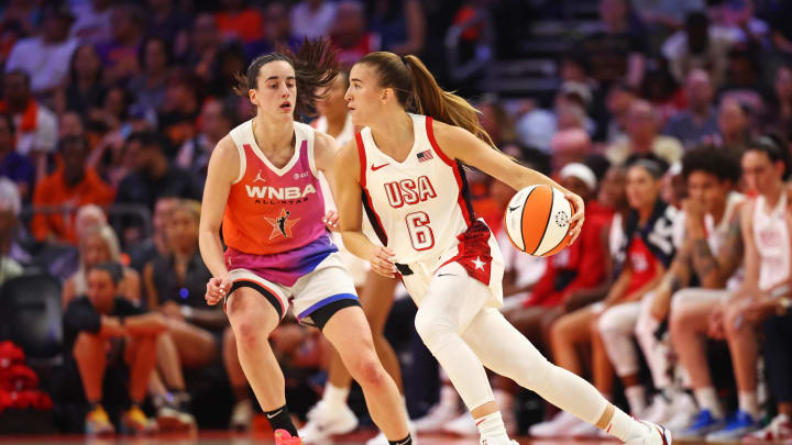 Jul 20, 2024; Phoenix, AZ, USA; USA Women's National Team guard Sabrina Ionescu (6) controls the ball as Team WNBA guard Caitlin Clark (22) defends during the first half at Footprint Center. Mandatory Credit: Mark J. Rebilas-USA TODAY Sports