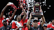 Mar 30, 2025; Indianapolis, IN, USA; Houston Cougars head coach Kelvin Sampson holds the trophy on stage after defeating the Tennessee Volunteers during the Midwest Regional final of the 2025 NCAA tournament at Lucas Oil Stadium. Mandatory Credit: Trevor Ruszkowski-Imagn Images