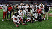 Oklahoma players settled for a photo just outside of the midfield logo on Saturday evening.