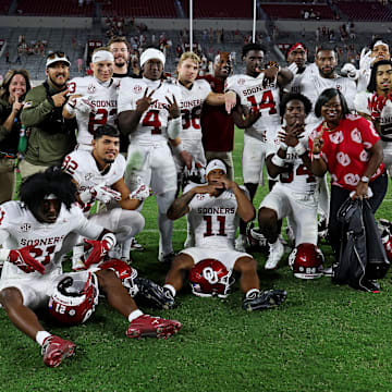 Oklahoma players settled for a photo just outside of the midfield logo on Saturday evening.