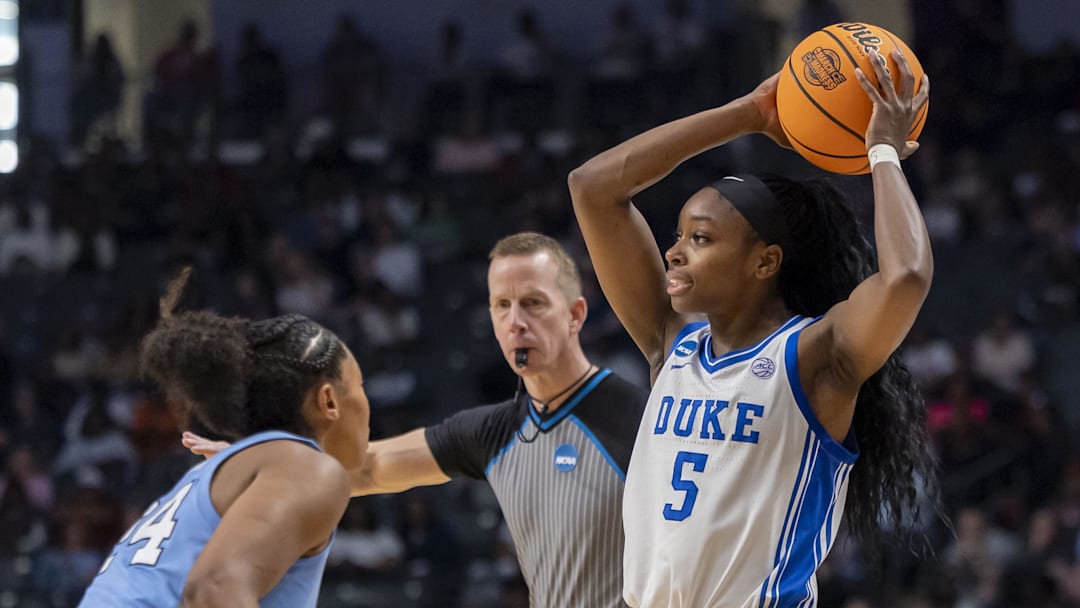 Mar 28, 2025; Birmingham, AL, USA; Duke Blue Devils guard Oluchi Okananwa (5) looks to pass over North Carolina Tar Heels guard Indya Nivar (24) during the Sweet 16 NCAA Tournament basketball game at Legacy Arena. Mandatory Credit: Vasha Hunt-Imagn Images